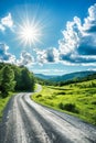 Sunny Day Over a Curved Country Road in a Lush Green Landscape Royalty Free Stock Photo