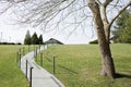 Sunny Day at the Park with a Winding Path Leading to a Cozy Building Royalty Free Stock Photo