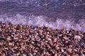 On a sunny day pebbles washed by small waves on the beach of the Black Sea Royalty Free Stock Photo