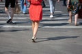 On a sunny day, pedestrians cross the street through a pedestrian crossing. There are pedestrian shadows on the street. View from Royalty Free Stock Photo