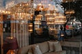 High Street, reflected in house furnishings window. Weybridge, Surrey.