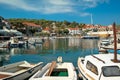 Sunny day in Postira Croatia, fishing boats in the port with view on the whole bay