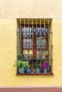 A sunny day reveals a stunning view of the balcony adorned with potted plants and windows, showcasing this impressive buildings Royalty Free Stock Photo