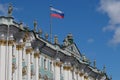 Sunny day in Saint-Petersburg, russian flag flying above facade of Hermitage State Museum Royalty Free Stock Photo