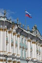 Sunny day in Saint-Petersburg, russian flag flying above facade of Hermitage State Museum Royalty Free Stock Photo