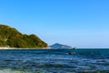 Sunny day, sand, clear turquoise sea, coral reefs on the coast of Xiaodonghai Bay in South China Sea. Sanya, island Hainan, China Royalty Free Stock Photo