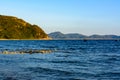 Sunny day, sand, clear turquoise sea, coral reefs on the coast of Xiaodonghai Bay in South China Sea. Sanya, island Hainan, China Royalty Free Stock Photo