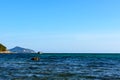 Sunny day, sand, clear turquoise sea, coral reefs on the coast of Xiaodonghai Bay in South China Sea. Sanya, island Hainan, China Royalty Free Stock Photo