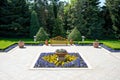 Sunny day in a spring garden with wooden bench, clay pots and blossoming flowers Royalty Free Stock Photo