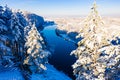 Sunny day starts over river in winter, aerial landscape. River shore concept. Snowy forest in rural area