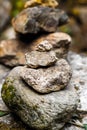 Sunny day stone tower old mossy stone from big small on a blurred background mountains zen rest trekking Royalty Free Stock Photo