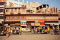 Sunny day on the street with rushing people and rickshaw taxi