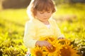 Happy child with bouquet of beautiful sunflowers.