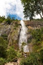 Sunny day in the Tropical waterfall falls from the mountain cliff to the jungle, serene landscape of Diyaluma falls.