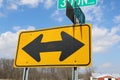 On a sunny day, two-way road sign with clouds