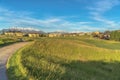 Sunny day view of pathway amid grassy ground leading to homes and golf course Royalty Free Stock Photo