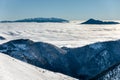Sunny day at winter Little Fatra mountains ridge above clouds