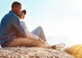Sunny days were made for outdoor dates. a happy young couple sitting on a rock and enjoying the ocean view.