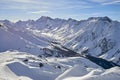 Sunny December day in Silvretta Alps - winter view on snow covered mountain slopes and blue sky Austria. Royalty Free Stock Photo