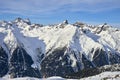 Sunny December day in Silvretta Alps - winter view on snow covered mountain slopes and blue sky Austria. Royalty Free Stock Photo