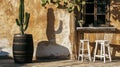 Sunny desert oasis: cactus shadow on rustic wall with wooden stools Royalty Free Stock Photo