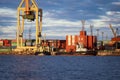 Sunny dock view of ships and large cargo containers. Royalty Free Stock Photo