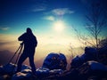 Sunny early winter morning. Photographer preparing camera on tripod. Royalty Free Stock Photo