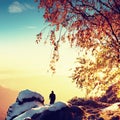 Sunny early winter morning. Photographer preparing camera on tripod. Royalty Free Stock Photo