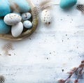 Sunny Easter background with Easter eggs on white table
