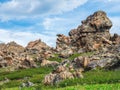 Sunny highland scenery with big stones of unusual shape. Awesome scenic mountain landscape with big cracked stones closeup among