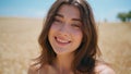 Sunny lady smiling meadow portrait. Young woman looking camera at summer field Royalty Free Stock Photo