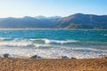 Sunny Mediterranean landscape on  windy day. Sea, waves and deserted pebble beach. Montenegro, Bay of Kotor Royalty Free Stock Photo