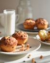 Sunny morning breakfast caramel and chocolate muffins with glass of milk