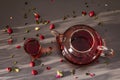 Sunny morning breakfast. Sweet raspberry green tea in glass kettle with dry fruits, flowers and leaves Royalty Free Stock Photo