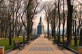 Sunny morning landscape view of the Monument of Volodymyr The Great. Straight stone walkway in the park.