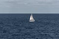 Sailboat heading north on a sunny morning at Punta Prima on the Island of Formentera, Spain