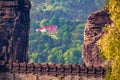 Sunny morning scene of sandstone cliff and reds roof house. Long focus summer view of Saxon Switzerland National Park Royalty Free Stock Photo