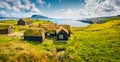 Sunny morning view of typical turf-top houses. Panoramic summer scene of outskirts of Torshavn city, capital of Faroe Islands, Kin