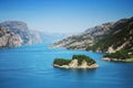 Sunny Norwegian fjord mountains with an island. Lysebotn, Norway.