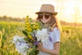 Sunny portrait of girl child in hat sunglasses with flowers in meadow Royalty Free Stock Photo