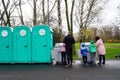 an outdoor setting with portable toilets in a park