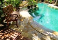 Sunny outdoor swimming pool and patio furniture