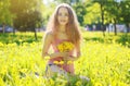 Sunny photo happy girl on yellow meadow with dandelions