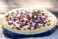 Sunny Photo with a morning breakfast in rustic style. Cheesecake raspberries and blueberries on wooden table.