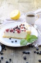 Sunny Photo with a morning breakfast in rustic style. Cheesecake raspberries and blueberries on wooden table.