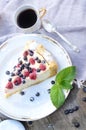 Sunny Photo with a morning breakfast in rustic style. Cheesecake raspberries and blueberries on wooden table.