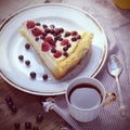 Sunny Photo with a morning breakfast in rustic style. Cheesecake raspberries and blueberries on wooden table. Square