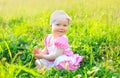 Sunny photo smiling child sitting on the grass in summer