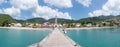 Sunny piers on the ocean with sailing boat - Martinique island, Anses Arlet village