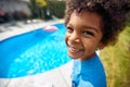 Sunny Poolside Bliss: Afro-American Boy\'s Infectious Laughter by the Water Royalty Free Stock Photo